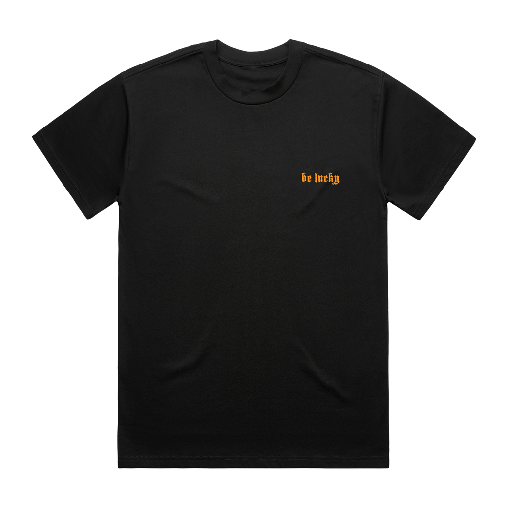 Black t-shirt with 'be lucky' text in orange printed on the front right chest.